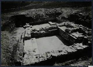 Excavated stone construction at Soli, Cholades, with a track running across the field behind it