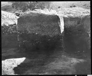 Soil section from the excavation at Mersinaki, with layers of earth and scattered stones in a cut face.