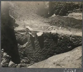 Soil section in an excavation trench at Mersinaki, with stones projecting from the earth face.