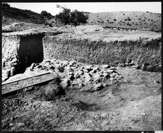 Soil section beside an excavated area with a scatter of stones at Mersinaki