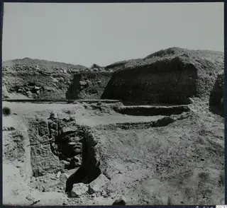 Excavation at Mersinaki with cut trenches, exposed stone walls and a rail track across the site