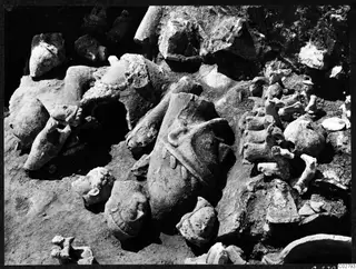 Broken statues and heads lying in excavated soil at Mersinaki, J 18-19