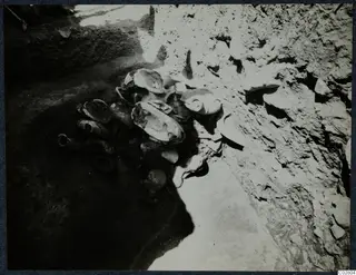 Vessels found in situ in pit G-I 14 at Mersinaki, lying against the earth wall of the pit