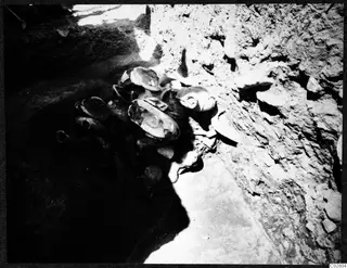 Objects lying in situ in pit G-I 14 at Mersinaki, clustered against an earth face.