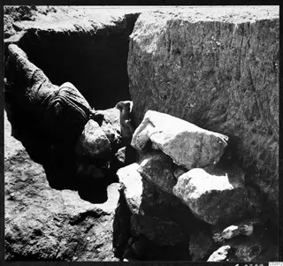Objects found in situ at Mersinaki in Pit II: stone blocks and a large curved object in the pit