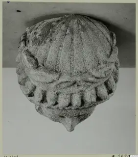 Limestone carved head or statue fragment from Kition, seen from the front against a grey backdrop