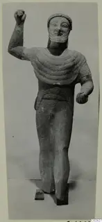 Limestone statue of a standing bearded figure from Kition, one arm raised