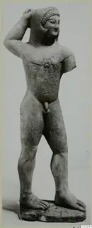Limestone statue of a standing nude male figure, one hand raised to its head, from Kition