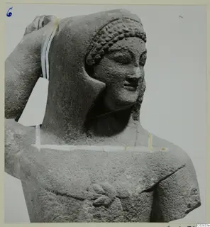 Limestone statue from Kition: head and upper body of a figure with curled hair and one arm raised