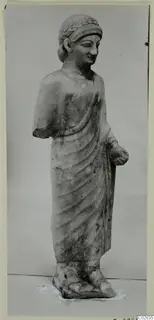 Limestone statue of a standing figure in a draped garment, from Kition