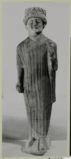 Limestone statue of a standing figure in a long robe and leafy headband, from Kition
