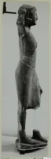 Limestone statue of a standing figure from Kition, seen in profile with one arm raised to the head