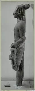 Limestone statue of a standing figure seen in profile, with a tall headdress, from Kition