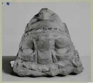 Carved stone sculpture fragment from Kition, with a rounded top, a twisted banded moulding and relief details