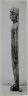Limestone statue of a standing figure from Kition, seen in profile, facing left.