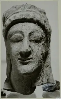 Limestone head from Kition with downcast eyes and a close-fitting headdress, neck broken off