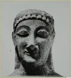 Limestone head statue from Kition, seen front-on with lowered eyes and hair held by a band