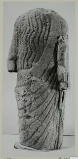 Limestone Cypro-Greek II statuette, headless figure with wavy lines carved down the back