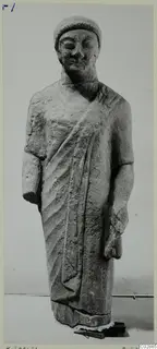 Limestone statue of a standing figure in a cap and cloak, from Kition