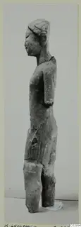 Limestone statue of a standing figure seen in profile, with the lower legs broken