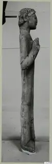 Limestone statue of a standing figure in profile, from Kition, with a hand raised to the chest