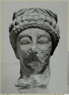 Limestone head from Kition with a tiered headdress and rounded curls
