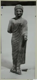Limestone statue of a standing figure in a long draped garment, from Kition