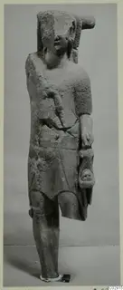 Limestone statue of a standing figure from Kition, with a broken headdress, cracked body and worn face.