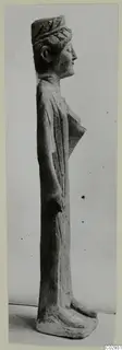 Standing limestone statue of a figure seen in profile, facing right, from Kition