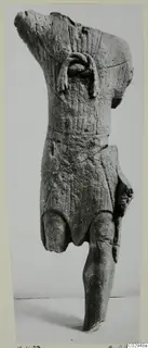 Limestone statuette fragment of a standing figure, head and upper body broken away, shown upright against a plain backdrop.
