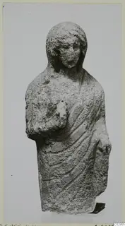 Limestone Cypro-Greek II statuette of a standing figure in a draped garment, from Kition
