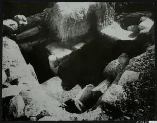 Excavation at Amathus showing a wall and scattered stones