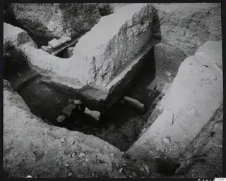 Excavation trench at Amathus with a raised pale wall and scattered stones on the floor of the cut