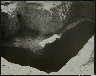 Excavation at Amathus showing a deep cut in the soil with stone blocks along its edge.