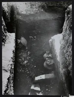 Excavation trench at Amathus with pottery vessels and stones on its floor