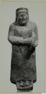 Limestone sculpture of a standing figure with arms folded across the chest, from Mersinaki