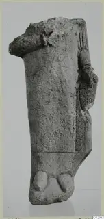 Fragment of a limestone statue from Vouni, broken at the top, with a projecting arm-like form at the right side