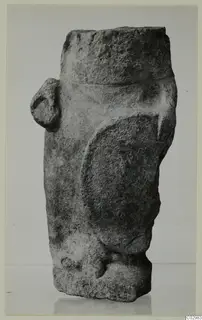 Limestone sculpture from Vouni with a cylindrical top, a large oval relief area and a small knob on the left side