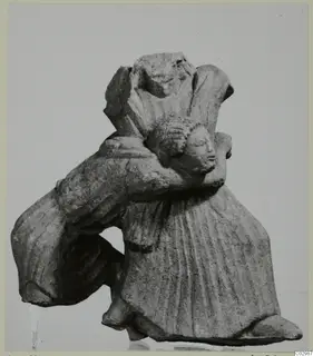 Limestone sculpture group of joined figures, one in a long pleated garment with a curly-haired head pressed against its shoulder