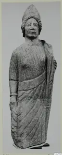 Limestone statue of a standing figure in a tall headdress with a draped garment, from Vouni