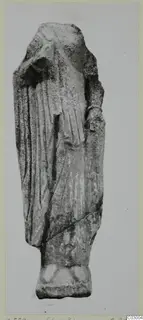 Limestone figure from Vouni, a standing draped figure with the head missing, shown on a rectangular base