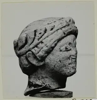 Stone head in profile facing right, with a banded headdress, from Vouni