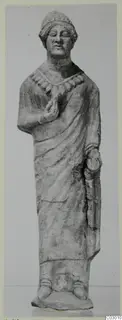 Limestone statue of a standing figure from Vouni, wearing a cap-like headdress and a necklace