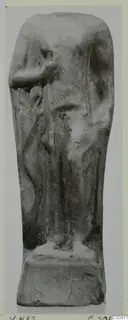 Figurine of a standing draped figure with one arm bent, on a rectangular base, upper part broken