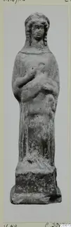 Terracotta figurine of a standing figure with long hair and hands raised to the chest, on a square base