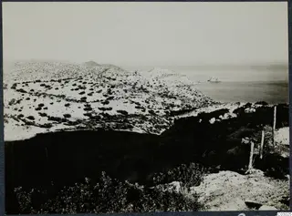 Coastal hills at Vouni with scrub vegetation, a rocky shoreline and the sea beyond.
