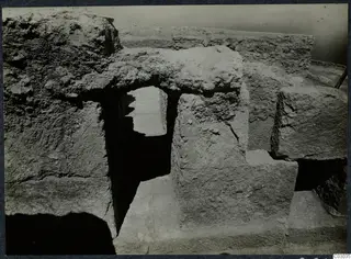 Large cut stone blocks and a narrow opening during excavation at the palace at Vouni