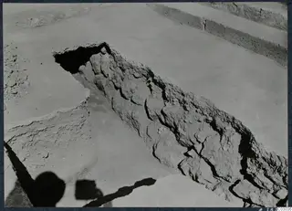 Excavation at Vouni palace showing a diagonal band of stones and packed earth, possibly a staircase, across a trench