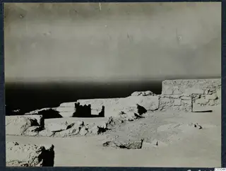 Ruined stone walls at Vouni with the sea on the horizon behind them