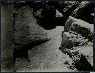 Stones during excavation at the palace at Vouni, with tumbled blocks and a trench floor between them